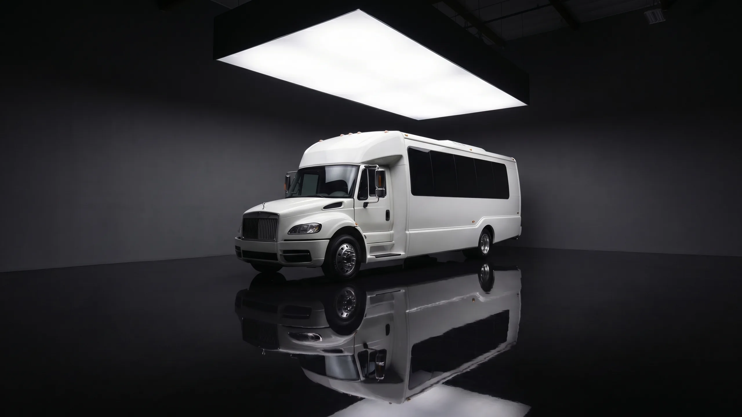 Seven Star Luxury Party Bus, a white 32-seat private touring coach in the showroom under a panel skylight — Vancouver group transport for weddings, galas, and celebrations